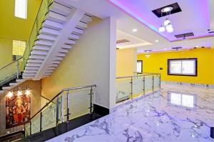 a staircase in a building with a marble floor at Hotel O SRI SAI PALACE in Bārang