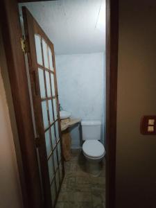 a bathroom with a toilet and a sink at Sitio canários 4 in Maricá +13 photos