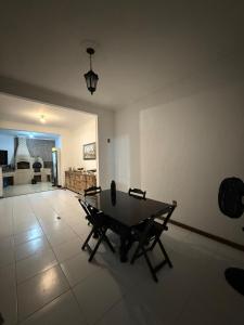 a living room with a table and chairs on a tile floor at Sitio canários 4 in Maricá