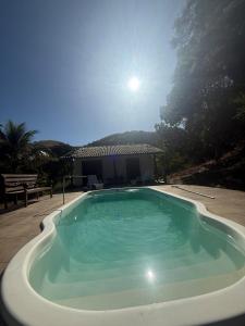 a large swimming pool in the middle of a yard at Sitio canários 4 in Maricá