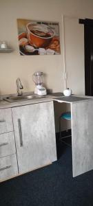 a kitchen counter with a sink and a bowl on the wall at KASA An in Machala