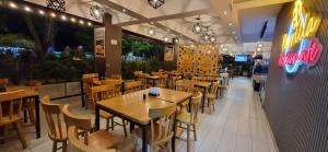 a dining room with tables and chairs in a restaurant at Hotel RUTA365 in Medellín
