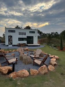 a building with benches and rocks in front of it at Tiny Escape Charlotte in Pak Chong