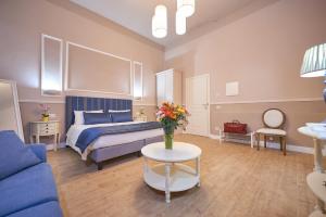 a bedroom with a bed and a vase of flowers on a table at B&B Le Stanze del Duomo in Florence