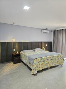 a bedroom with a large bed and a dresser at Casa Paraíso Tropical in Porto Seguro