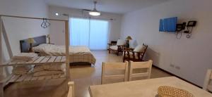 a room with a bed and a table and chairs at B&B Mono Ambiente in Concordia