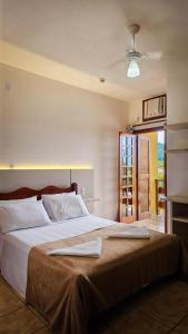 a bedroom with a large bed with at Pousada Ubatuba Villa Tupi in Ubatuba +23 photos