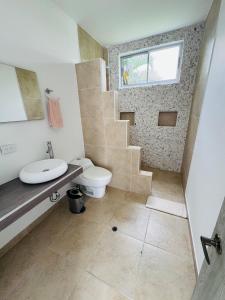 a bathroom with a toilet sink and a staircase at Finca de lujo con picsina en San Jerónimo Antioquia in San Jerónimo