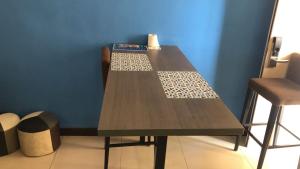a wooden table in a room with a chair at MZ Guesthouse Bayou Studio Jakuzi in Kampong Bukit Beruang