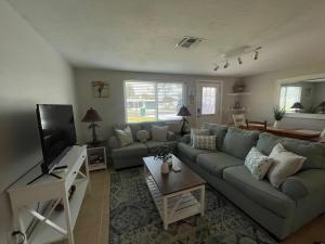 Una sala de estar con un sofá y un televisor. en Close To Beach! 3 Bedroom 2 Bath, en Englewood