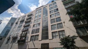 a tall building with windows on the side of it at Vive Centro Histórico CDMX in Mexico City