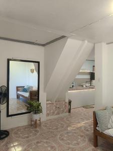 a living room with a mirror and a bedroom at Ocean View Villa 1 in General Luna