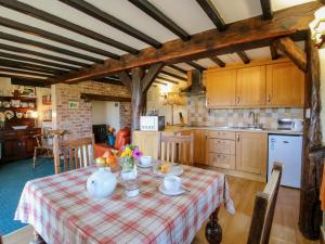 a kitchen with a table with food on it at White Cottage in Hopton Wafers