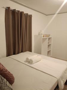 a bedroom with a bed with two towels on it at Ocean View Villa 1 in General Luna +19 photos