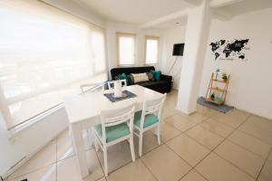 a living room with a white table and chairs at departamento vida in Ushuaia +2 photos