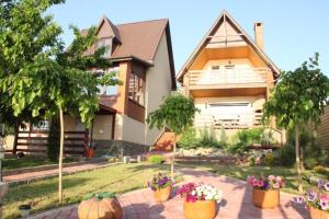 a house with pumpkins and flowers in front of it at Два дома на берегу Лимана in Vapnyarka