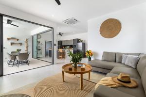 a living room with a couch and a table at Villa Laura by See Residence -Near Cystal bay- Inclued Airport pick up in Amphoe Koh Samui