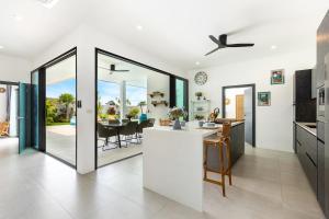 a kitchen and dining room with a view of a table at Villa Laura by See Residence -Near Cystal bay- Inclued Airport pick up in Amphoe Koh Samui