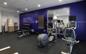 a gym with cardio equipment and a blue wall at Holiday Inn Express & Suites Oklahoma City Northwest by IHG in Oklahoma City