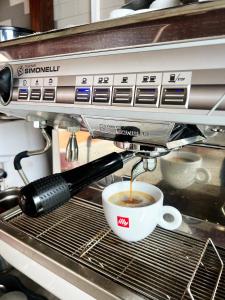 a coffee maker is making a cup of coffee at Lakeside Inn in Guilin