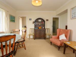a living room with a table and chairs at Tegawelon in Harlech