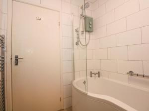 a white bathroom with a tub and a shower at Tegawelon in Harlech +34 photos