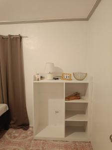 a white shelf in a room with a lamp at Ocean View Villa 1 in General Luna