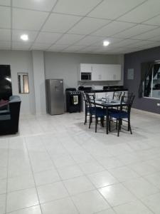a room with a table and chairs and a kitchen at Apartamento familiar 1 con 3 habitaciones y 4 camas in San Salvador