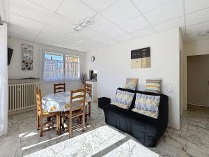 a living room with a couch and a table at Confortable appartement proche du Port Guillaume pour 4 avec animaux admis - FR-1-465-125 in Dives-sur-Mer