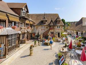 a group of people walking around a town with buildings at Confortable appartement proche du Port Guillaume pour 4 avec animaux admis - FR-1-465-125 in Dives-sur-Mer