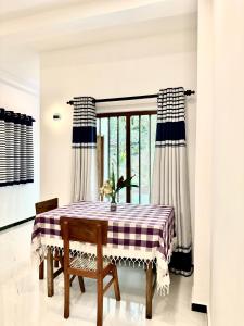 a dining room with a table and a window at Tobby Home Stay in Ahangama +38 photos