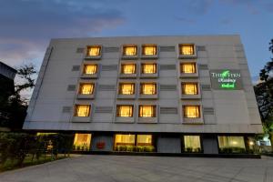 a large building with lights in the windows at The Fern Residency Woodland, Pune in Pune