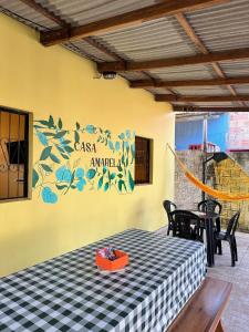 a table with a black and white checkered table cloth at Casa Amarela in Presidente Figueiredo