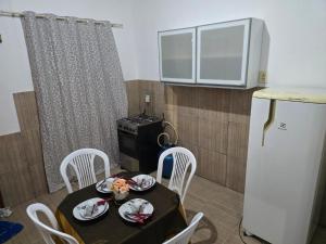 a small kitchen with a table and a refrigerator at Apto J com cozinha em Macapá in Macapá
