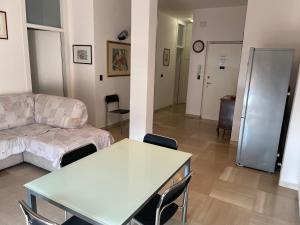 a living room with a couch and a table at DOLOMITI 5.3 in Verona