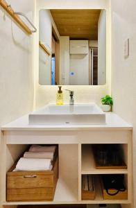 a bathroom with a white sink and a mirror at SUN House asakusabashi akihabara tokyo in Tokyo +93 photos