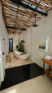 a bathroom with a large tub and a sink at Ecstatic Villa, heart of Uluwatu in Uluwatu