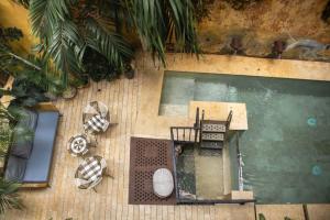 an overhead view of a swimming pool with plants at Hotel Casa La Factoria by Faranda Boutique, a member of Radisson Individuals in Cartagena de Indias +21 photos