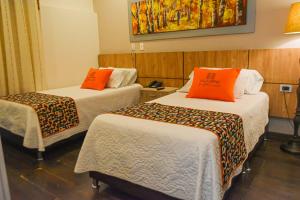 Voodi või voodid majutusasutuse Hotel Ucla Center toas