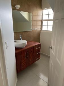 a bathroom with a sink and a mirror at Hermosa casa entera cerca de la Presa del Rejón in Chihuahua +25 photos