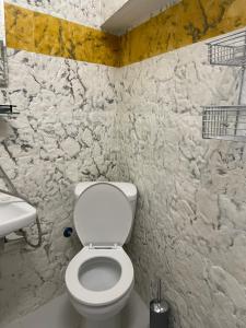 a bathroom with a white toilet and a sink at Wooden interior in village krini. in Corfu Town +11 photos