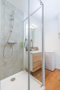 a bathroom with a shower and a sink at Cosy Nest - parking - Netflix in Valence