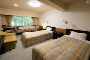 Postel nebo postele na pokoji v ubytování Ichirino Kogen Hotel Roan