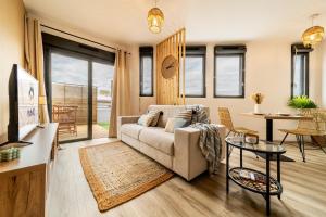 a living room with a couch and a table at Oasis T2 avec terrasse en bord de mer in Saint-Pierre