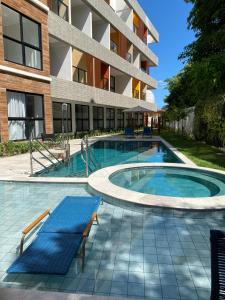 a swimming pool in front of a building at Flat na beira-mar de Tamandaré in Tamandaré