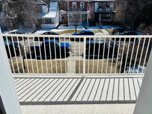 a white fence on a porch with snow on the ground at Upper Floor Private 1-Bedroom Suite with Parking in Calgary