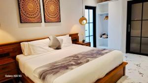 a bedroom with a large bed in a room at Vila Cartenz in Jimbaran +56 photos