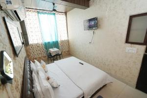 a hospital room with a bed and a television at Swagat Guest House in Dehradun
