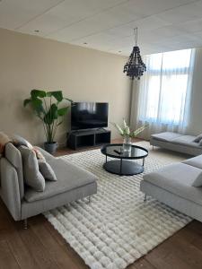 a living room with a couch and a coffee table at Saya Loft in Amersfoort
