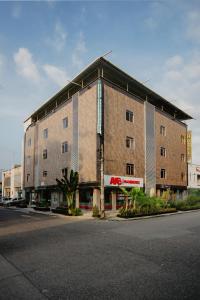 a large building on the side of a street at Hotel Plataneras Plaza in Apartadó